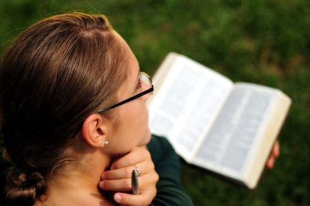 Reading Bible in Park