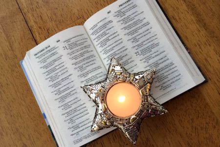 Bible Open to Proverbs 20 with Jerusalem Candle